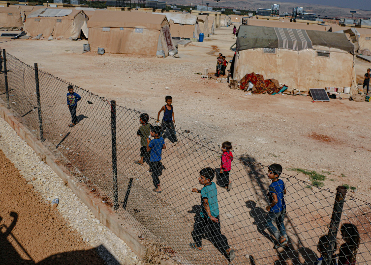 Kids running looking for help in refugee camp