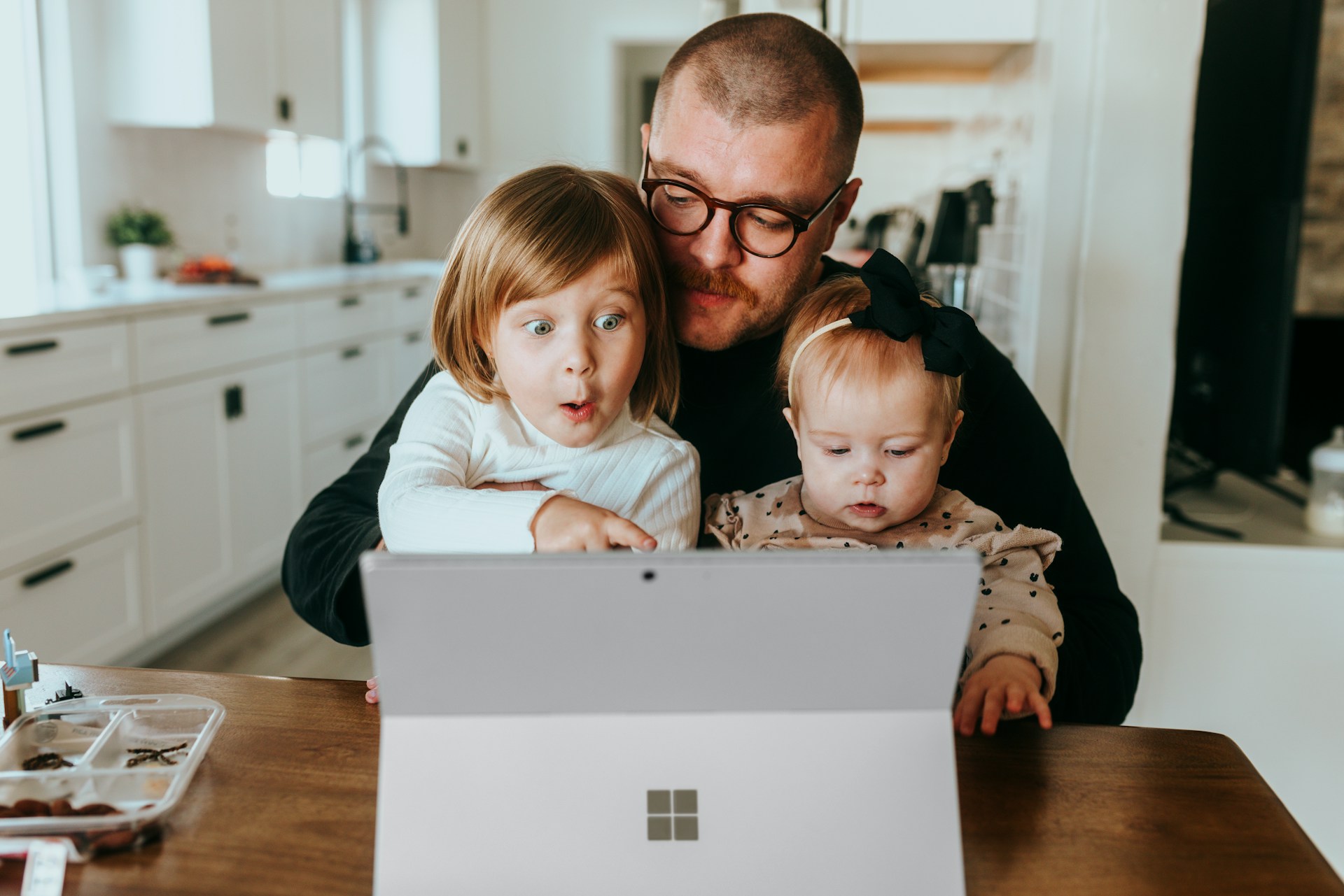 Professional relocation guide: A father and his two children using the computer