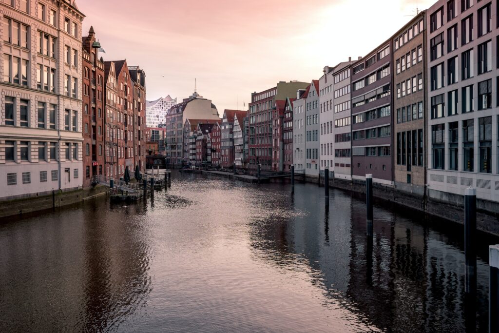 The City Guide to Hamburg: a view of a canal with the Elbphilharmonie in the background.