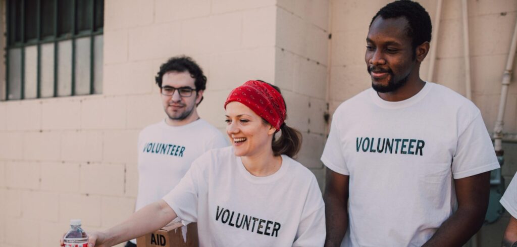 Volunteering brings great benefits. Three volunteers in t-shirts