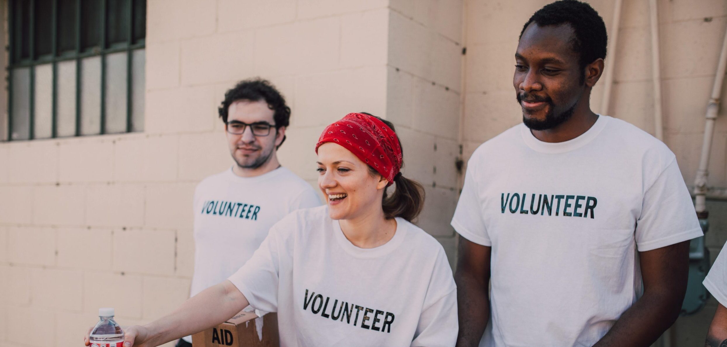 Volunteering brings great benefits. Three volunteers in t-shirts