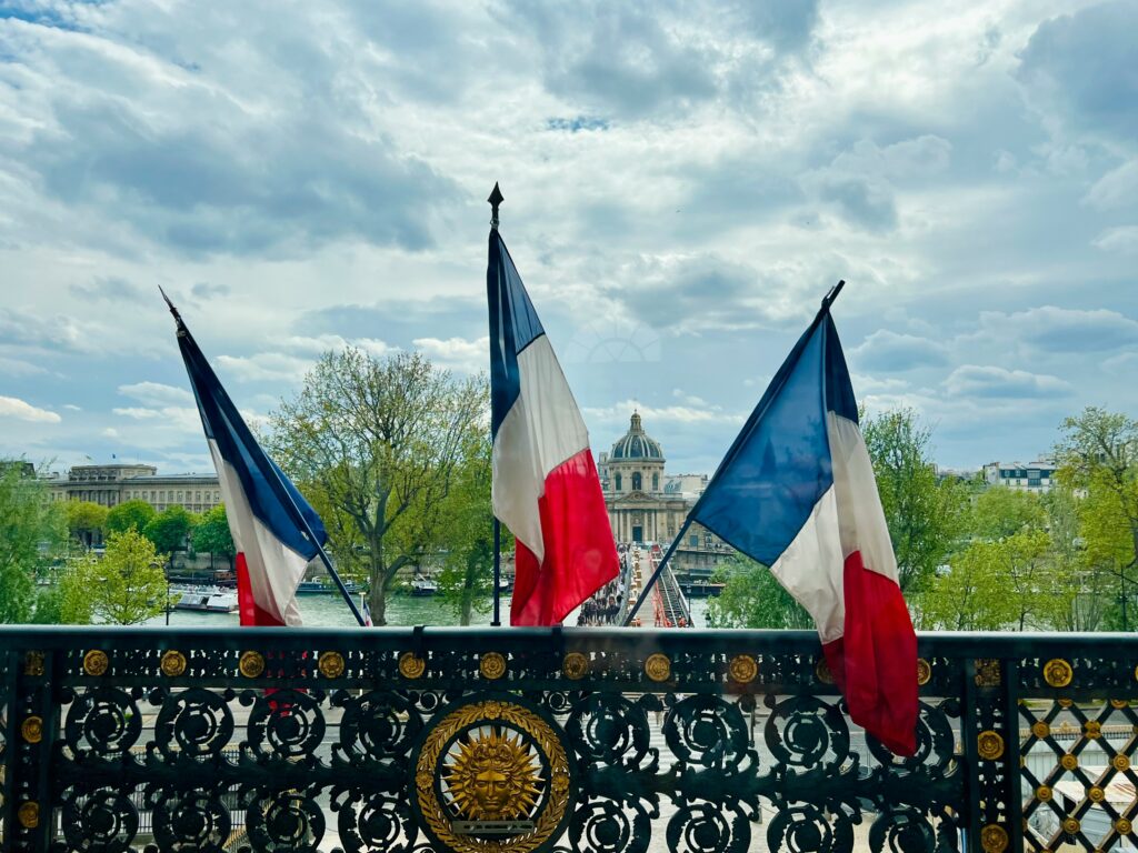 three French flags on a railing
