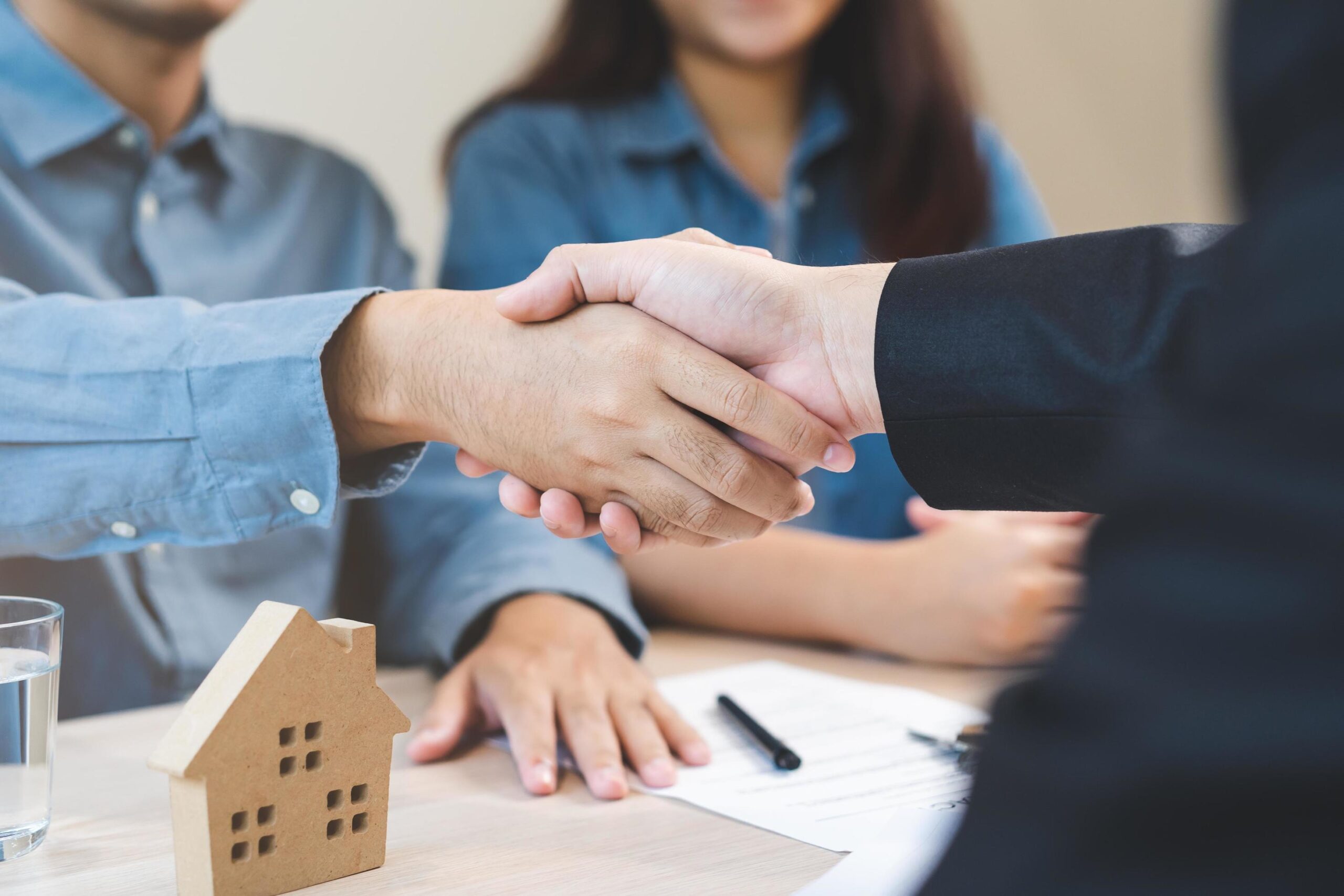 shaking hand over a legal document